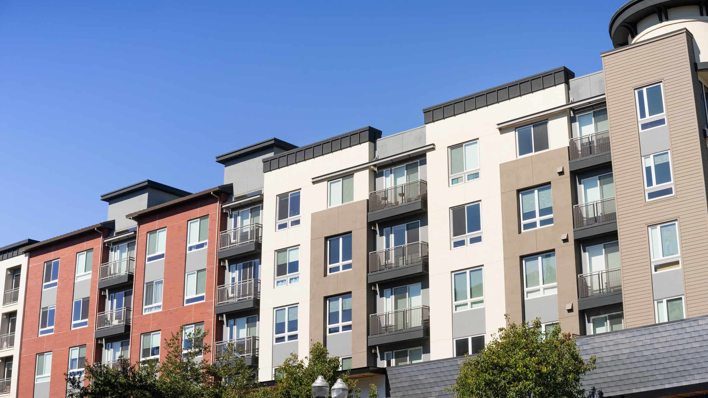 Exterior view of modern apartment building offering luxury rental units